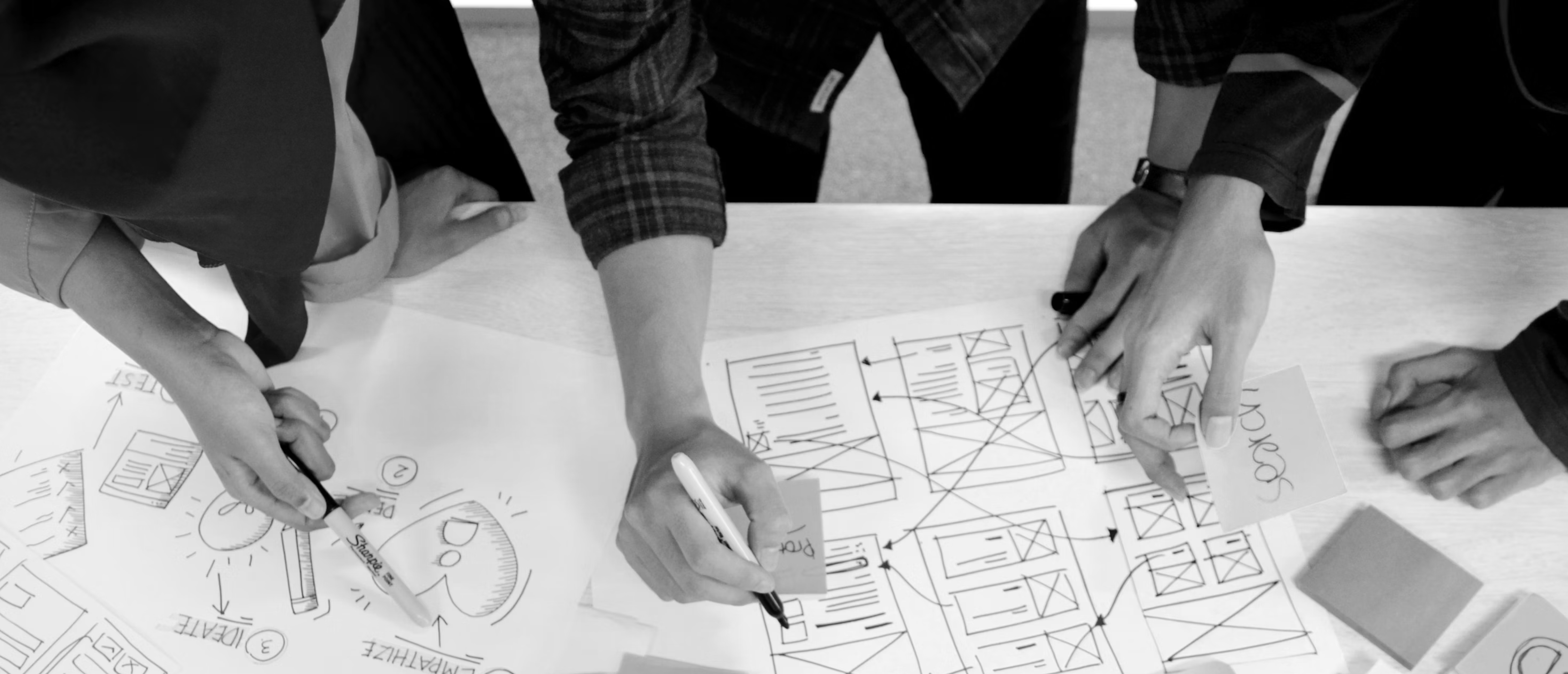 hands-working-on-the-blueprints-desktop