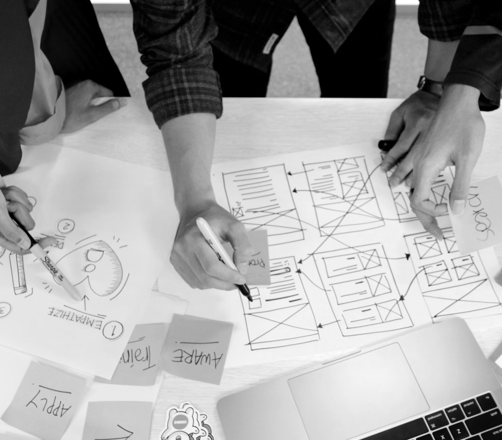 hands-working-on-the-blueprints-mobile